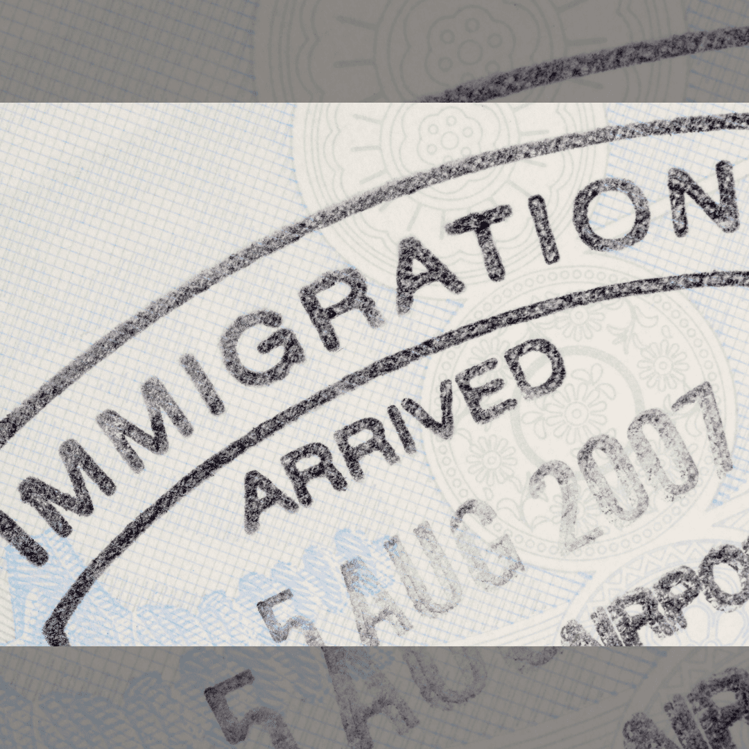 An Immigration Stamp in Black on a Passport Paper