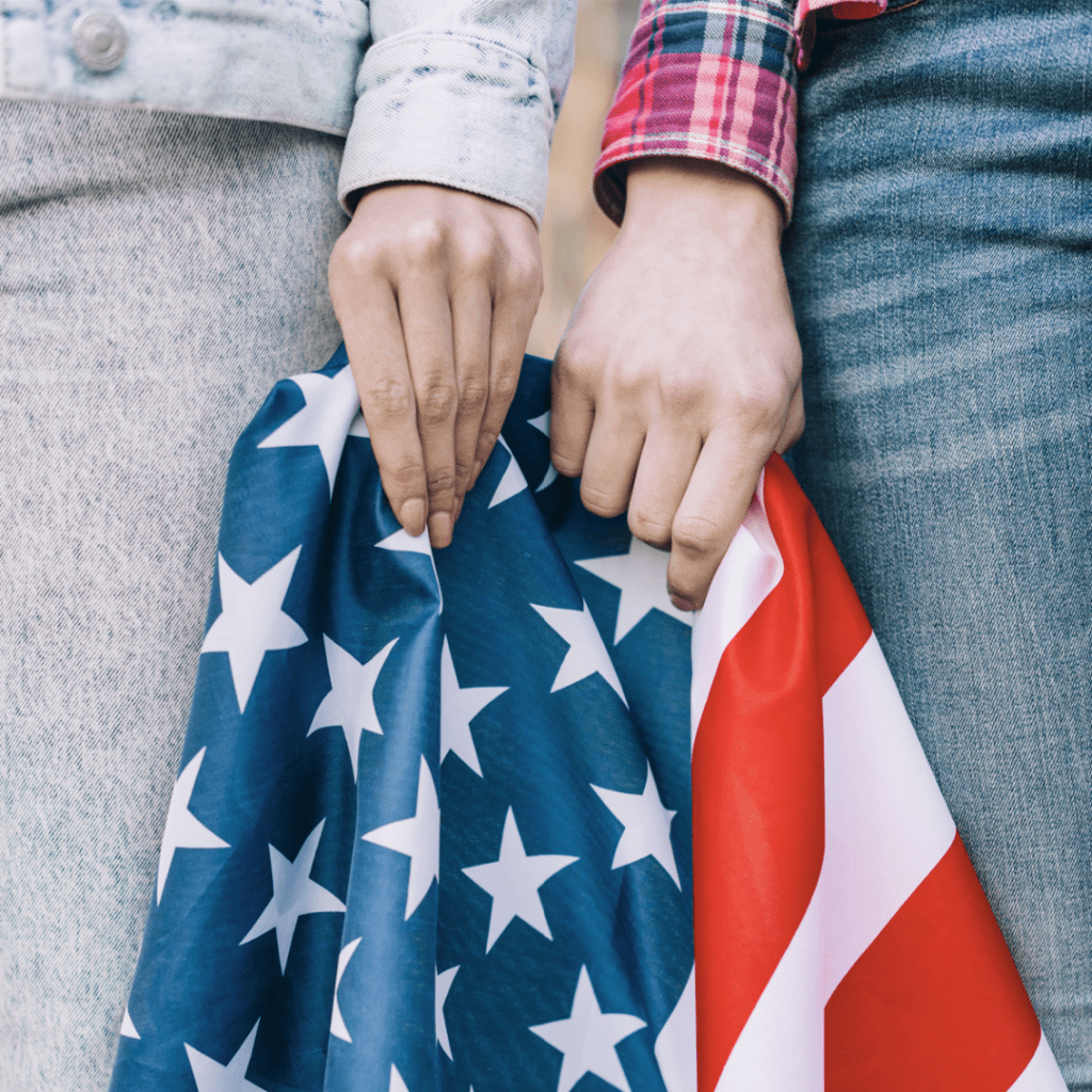 A Couple Holding Out an American Flag in Hand